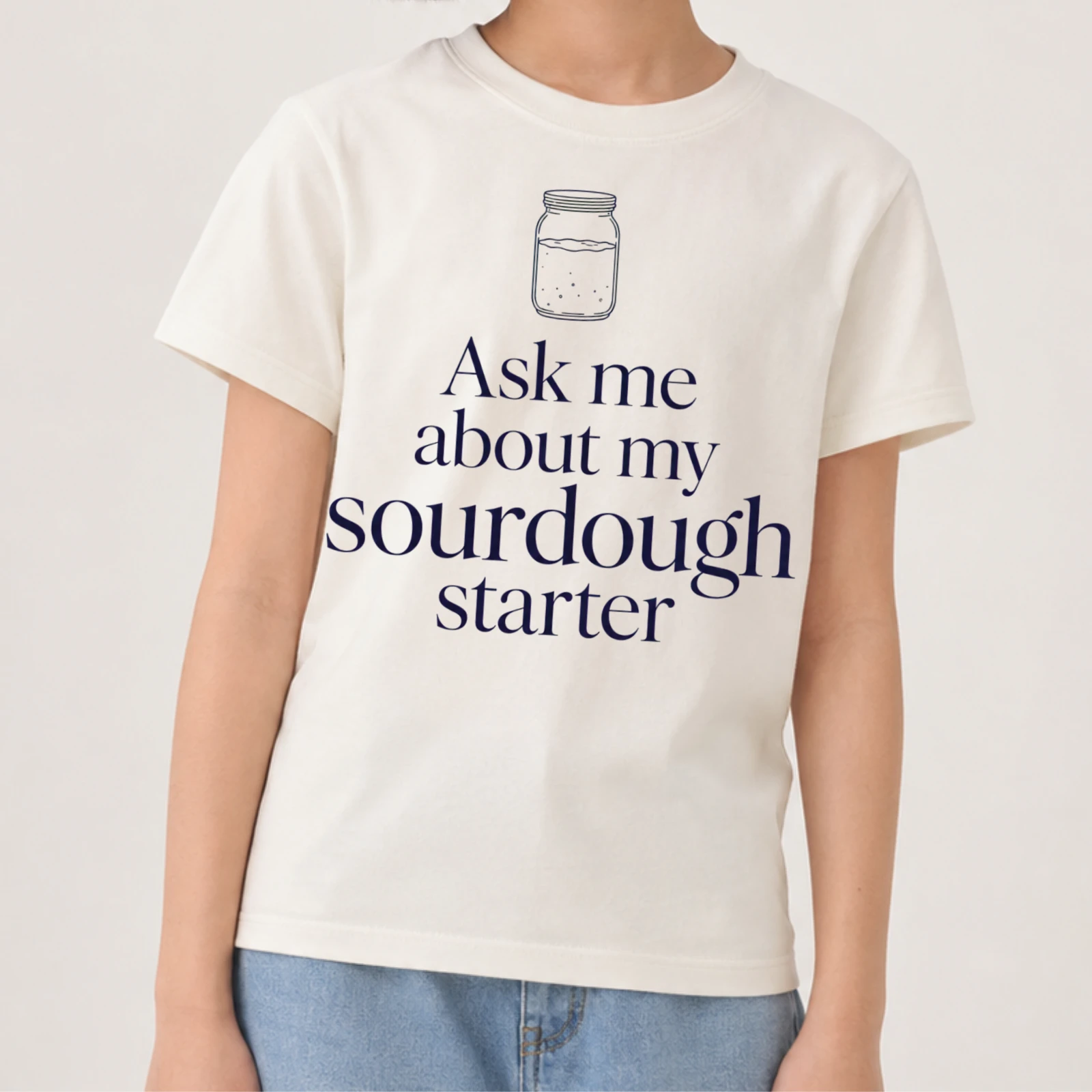 Girl wearing the Ask Me About My Sourdough Starter tee, cropped above the face